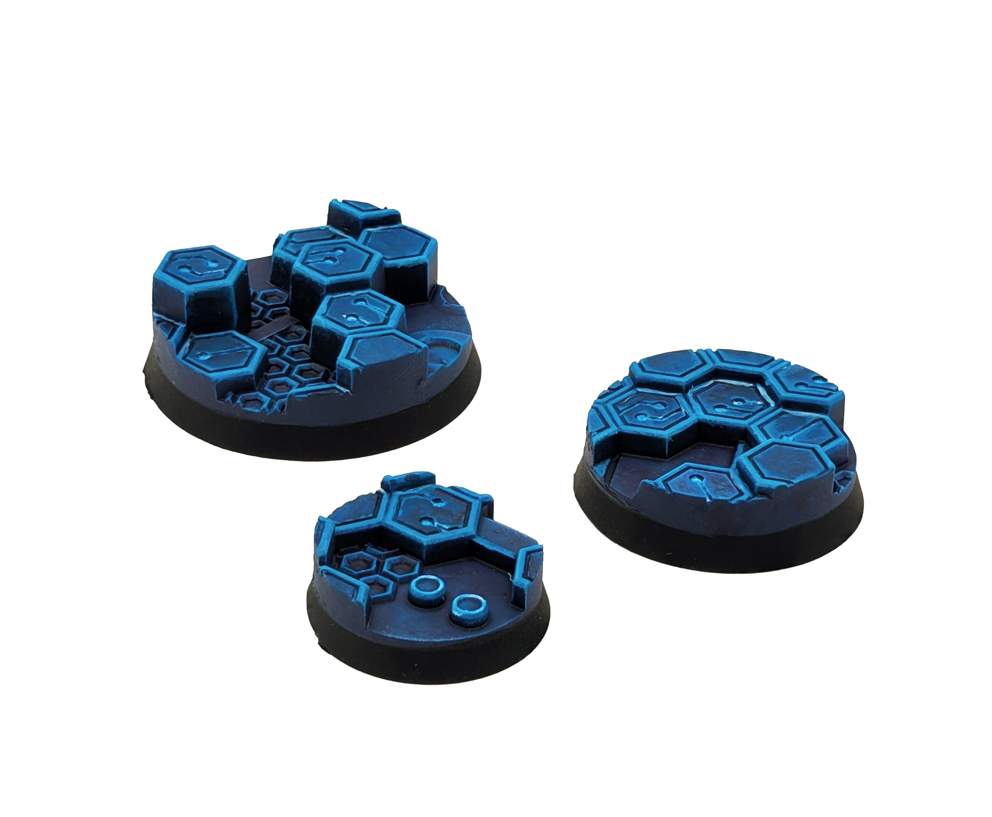 Three painted bases from the Txarli Cyber Hex set on a plain white background. 25mm, 32mm and 40mm
