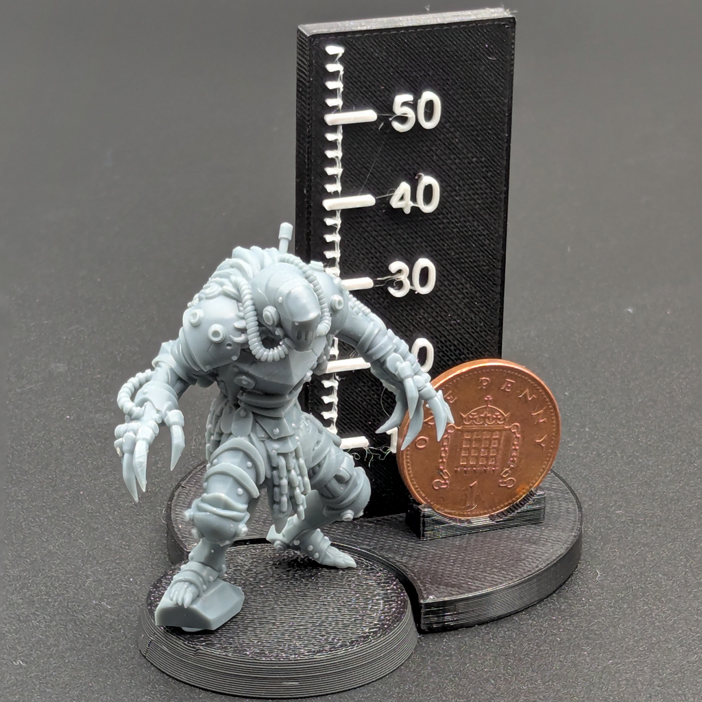 Hellbound Apostasy DeathCommando. Printed in grey resin, next to a scale showing height with a UK penny as a reference.