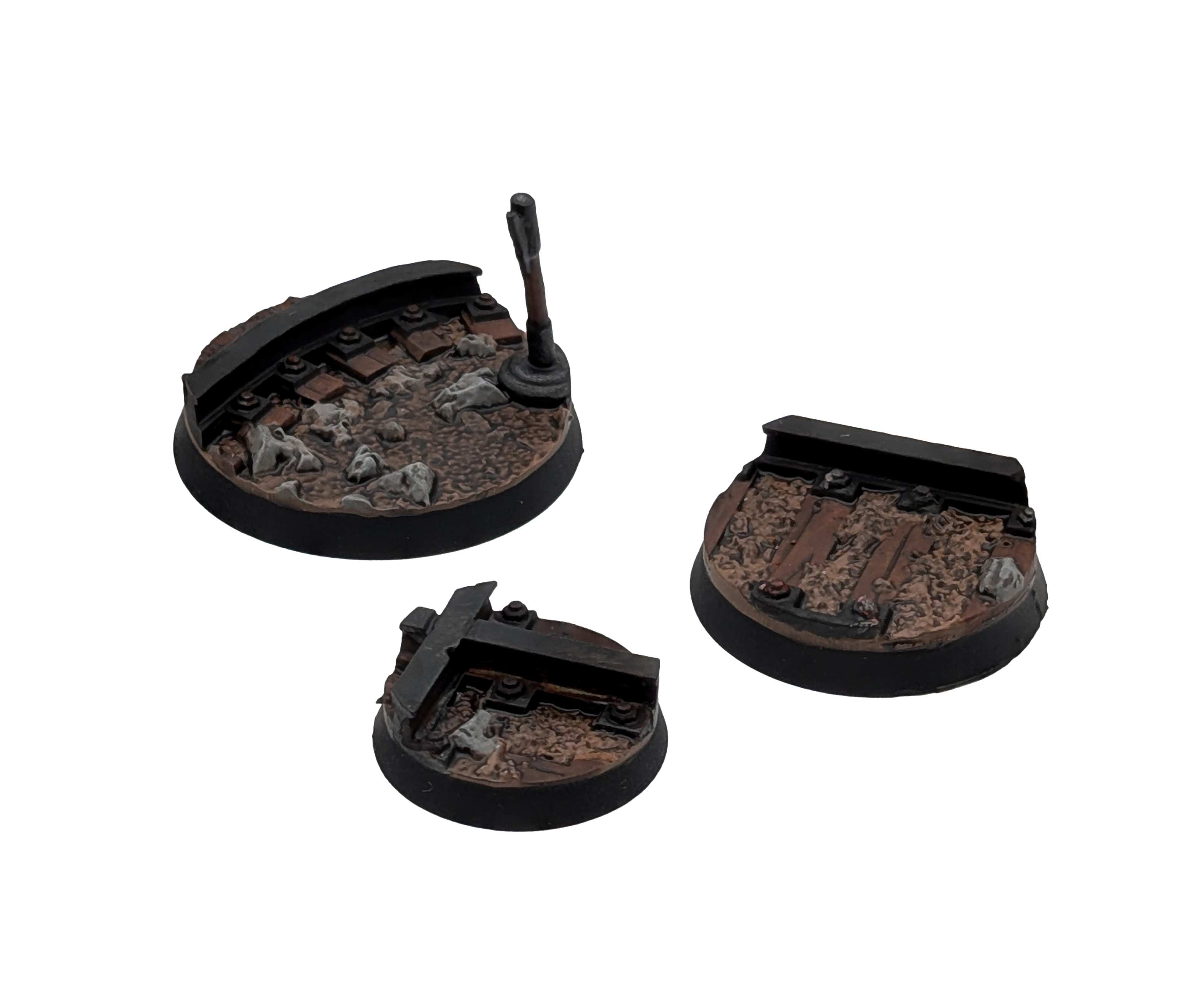 Three Txarli Factory Mines Scenic Bases 40mm, 32mm and 25mm. Shown painted on a white background.