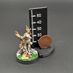 A painted Pox Charger from the Ugni Mouldering Mayhem team. Standing next to a penny for scale.