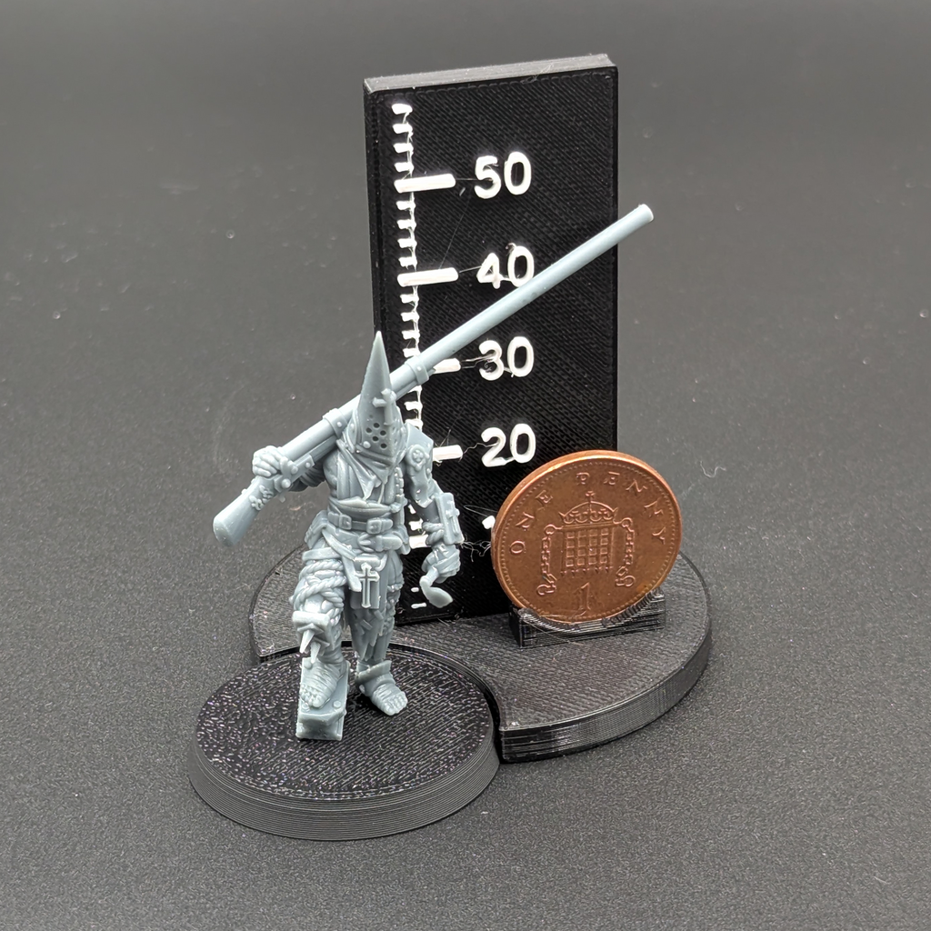 An Ashen Armies Puntgun Pilgrim from the Bleeding Procession Warband. Standing next to a penny for scale.