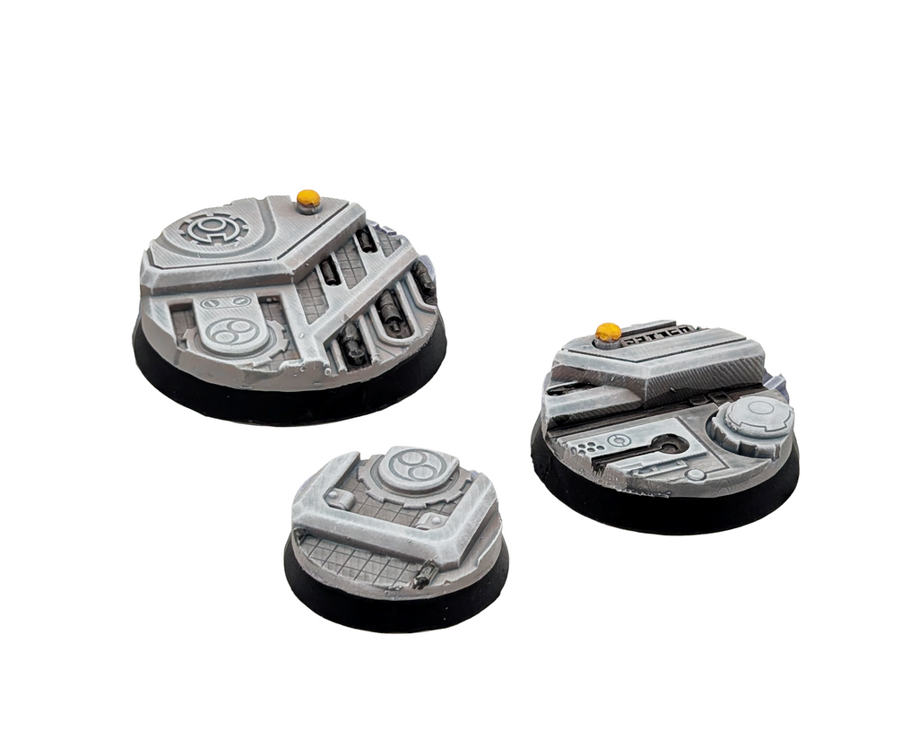 Three painted bases from the Txarli Xeno City set on a plain white background. 25mm, 32mm and 40mm