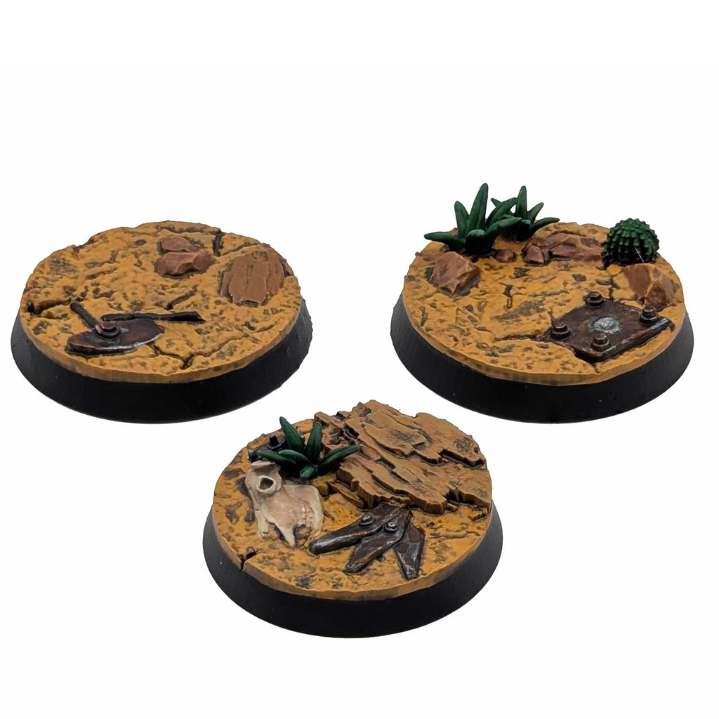 Three round miniature bases with textured surfaces and small figures on a white background