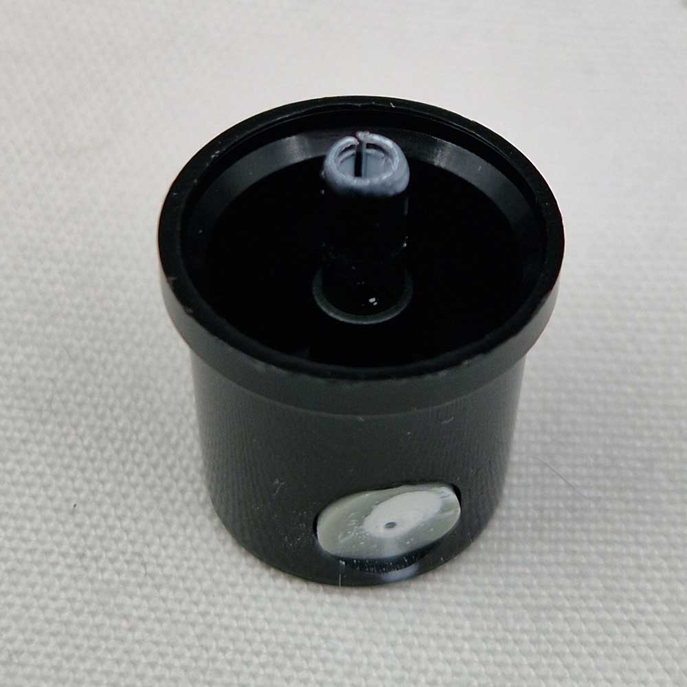 Close up photograph of one previously very dirty spray can cap that has been cleaned. As per the spray can caps guide.