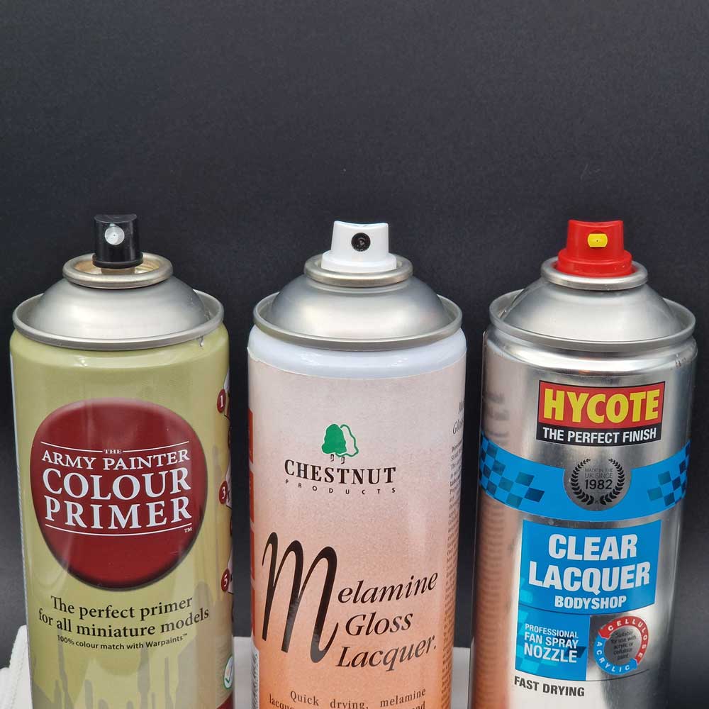 Photograph showing three different cans with different styles of can caps.
